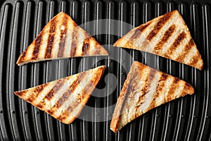 Modern sandwich maker with bread slices, top view