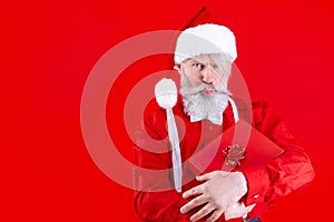 Modern Santa Claus isolated on red background. Merry Christmas and Happy New Year concept