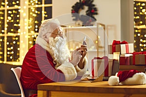 Modern Santa Claus text messaging and ordering presents delivery using phone app