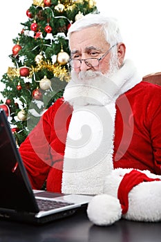 Modern Santa using laptop