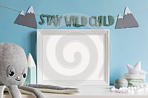 The modern scandinavian newborn baby room with mock up frame, wooden toys, plush animals, children accessories.