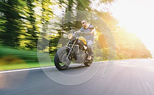 Modern scrambler motorbike on the road riding a motorcycle at sunset. copyspace for your individual text