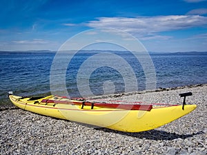 Modern sea kayak with traditional Greenland style paddle.