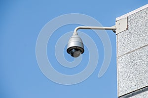 Modern security camera over blue sky