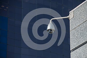 Modern security camera over office building