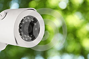 Modern security CCTV camera outdoors, closeup. Space for text