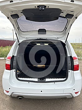 Modern sedan car have an open trunk. The car boot is open and ready for luggage loading. Empty space at the boot of the