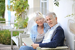 Modern senior couple connected to wifi