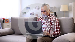 Modern senior freelancer working remotely at home, business online in internet