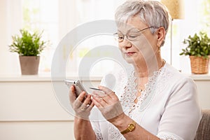 Modern senior woman with pda photo