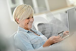 Modern senior woman shopping on internet