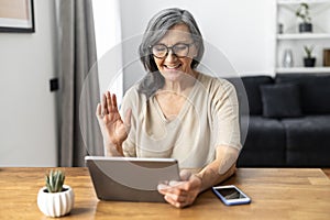 Modern senior woman using a tablet