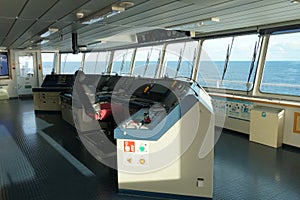 The Modern ShipÃ¢â¬â¢s Bridge control console with navigational equipment of container ship with view on the sea.