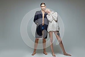 Modern shoot of slim couple in big jacket and sweater on naked body