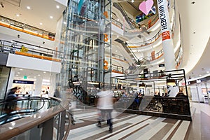 Modern shopping mall with hurrying people