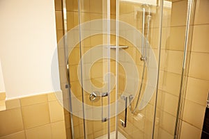 Modern shower with glass cabin inside bathroom interior