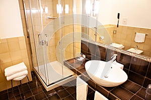 Modern shower with glass cabin inside bathroom interior