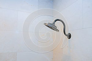 Modern shower head showing drops and streams of water