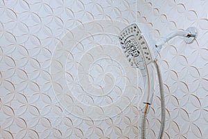 Modern shower head showing drops and streams of water