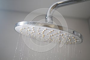 A Modern Showerhead Designed for Optimal Water Flow in a Stylish Minimalist Bathroom Setting photo