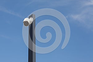 Modern singiel CCTV, white security camera against blue sky background