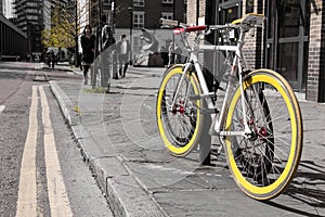Modern single gear bycicle with yellow tyres photo