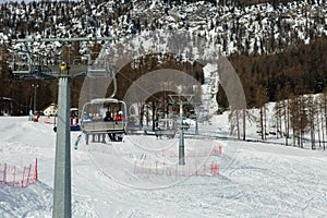 Modern Ski Lifts with Skiers in Italian Dolomites Alps in Winter Day with Snow