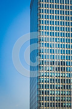 Modern skyscraper with blue sky on the background