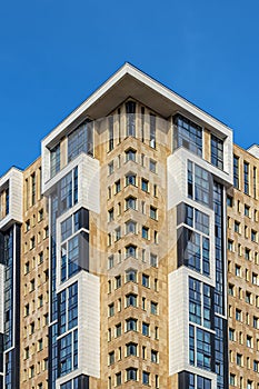 Modern skyscraper under construction against the blue sky