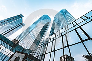 Modern skyscrapers in business district against blue sky