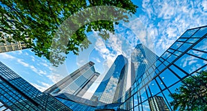 Modern skyscrapers in business district against blue sky