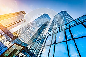 Modern skyscrapers in business district at sunset with lens flare