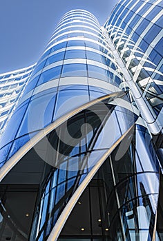 Abstract blue high rise commercial building skyscraper made of glass exterior. Modern skyscrapers in business district