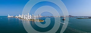 The modern skyscrapers in the Cartagena in Colombia with sea port and cargo ship aerial panorama view