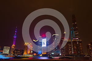 Modern skyscrapers of Shanghai cityscape at night with reflection, Shanghai, China