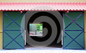 Modern sliding doors at horse stable and riding school in barn at farm