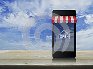 Modern smart mobile phone with on line shopping store graphic