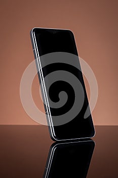 Modern Smartphone with Blank Black Screen for Mockup, Sleek Design, Reflecting on Glossy Surface.