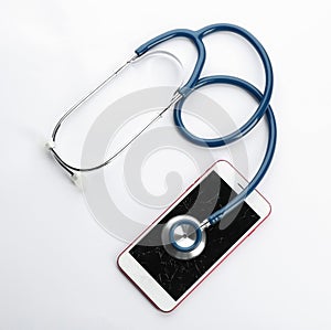 Modern smartphone with broken display and stethoscope on white background. Device repair service