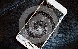 Modern smartphone with broken screen.