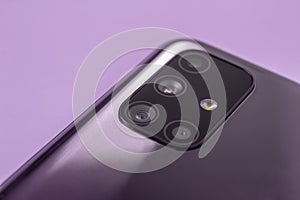 A modern smartphone with multiple camera lenses and a built-in close-up flash