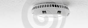 Modern smoke-alarm as panorama on the ceiling