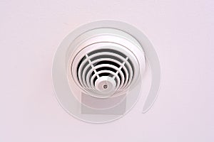 Modern smoke sensor installed on ceiling