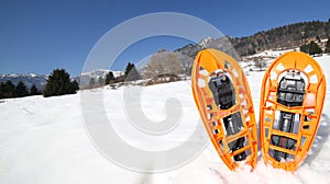 Modern snowshoes in the mountain photo