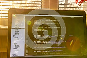 Modern software development background: nice looking laptop with programm