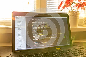 Modern software development background: nice looking laptop with programm photo