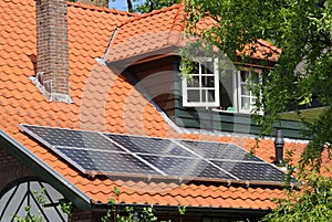 Modern solar panels as an alternative energy source on scenic red tiled roof, Netherlands