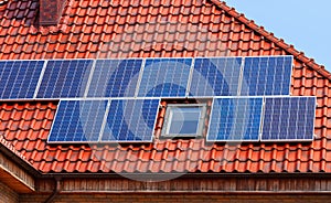 Modern solar panels on a red tiled roof