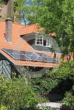 Modern solar panels at a red tiled roof, an alternative energy source,Netherlands