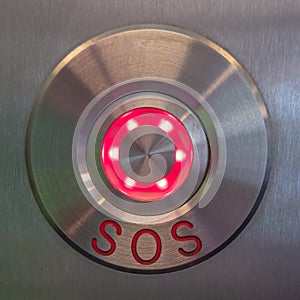 Modern SOS, help button made of stainless steel metal and illuminated glass indicator, details, closeup